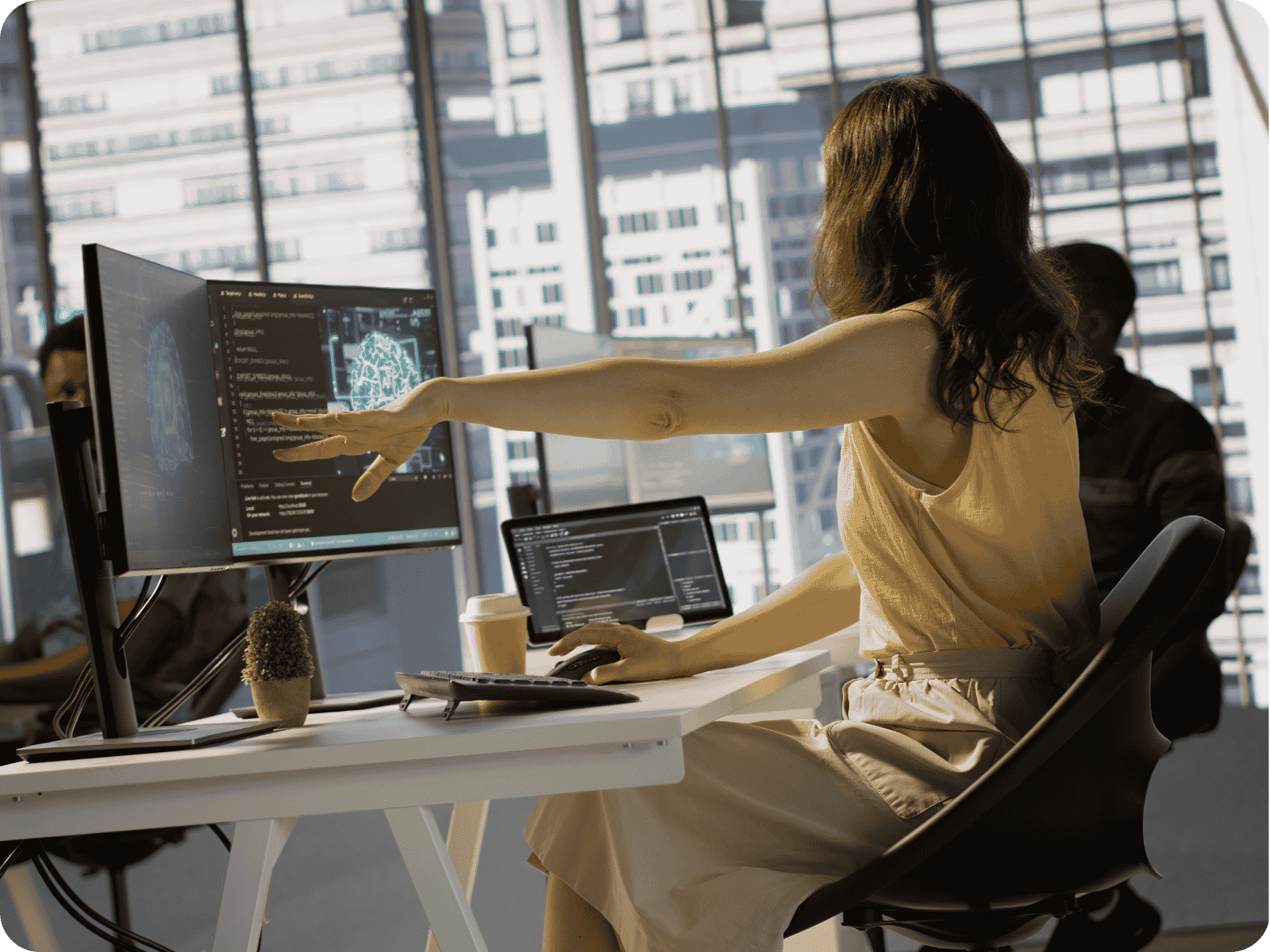 Developer building custom field service software at a multi-screen workstation